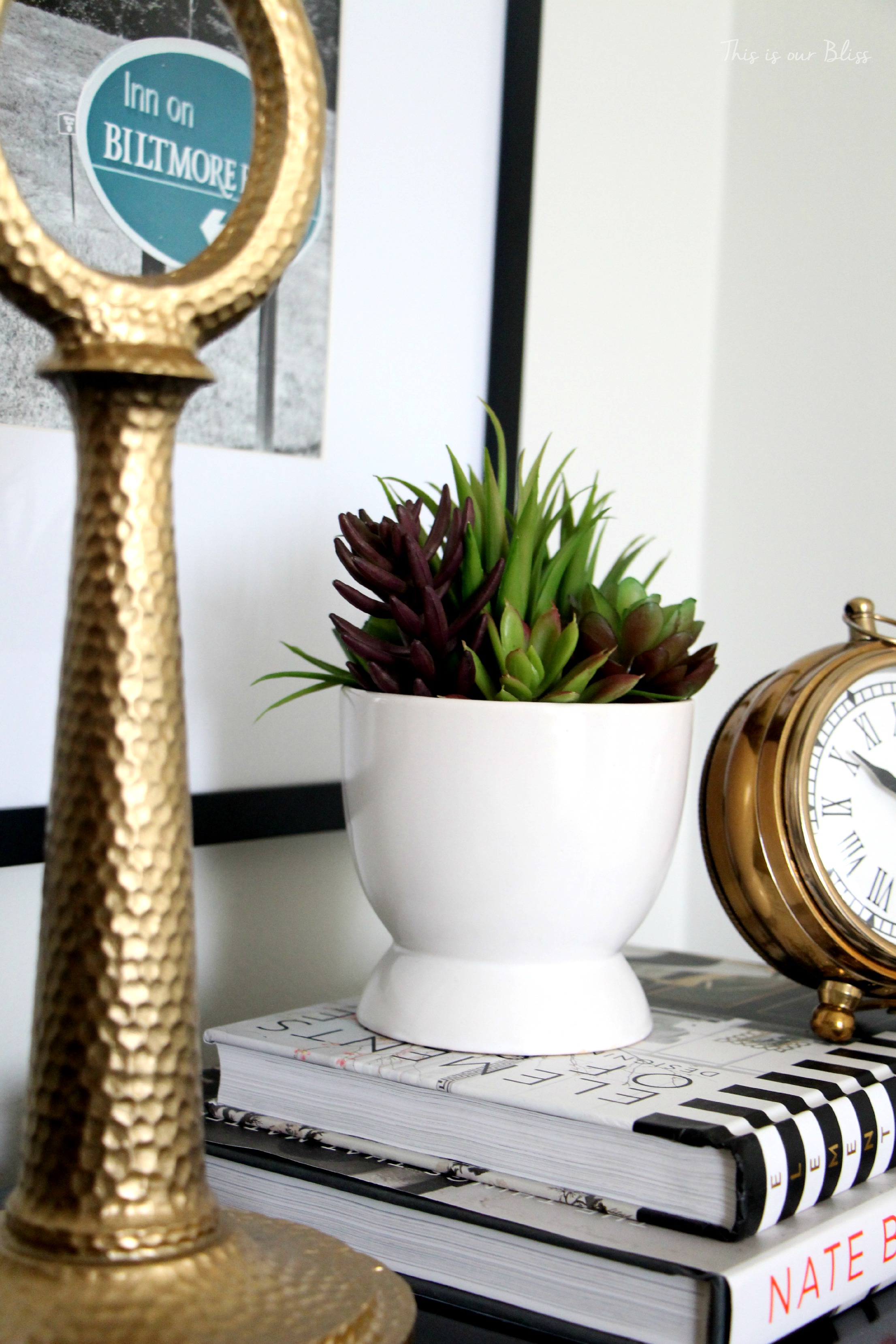 Guestroom revamp - bedside table - gold lamp & clock - succulent - design books- This is our Bliss