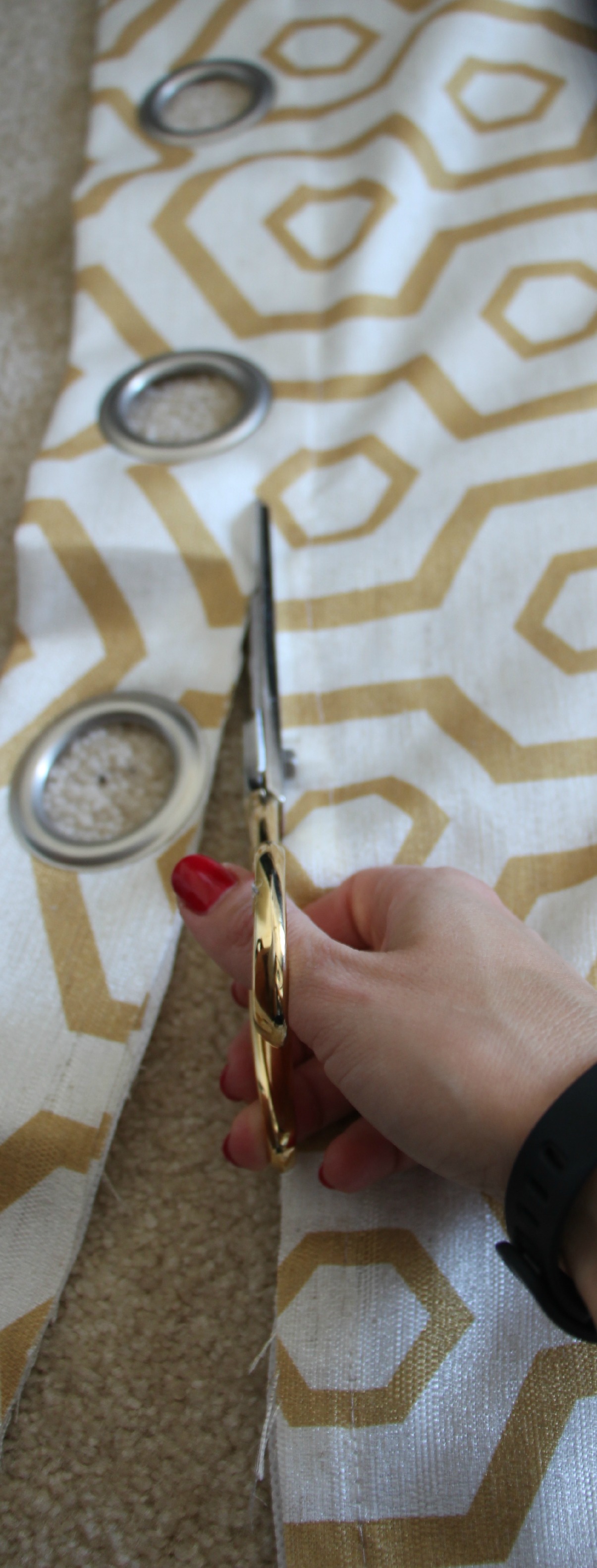 how to reupholster a headboard with a curtain panel - cutting grommets off - this is our bliss